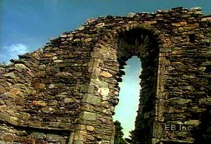 Walk through ruins of an Irish monastery from the Middle Ages in the Vale of Glendalough
